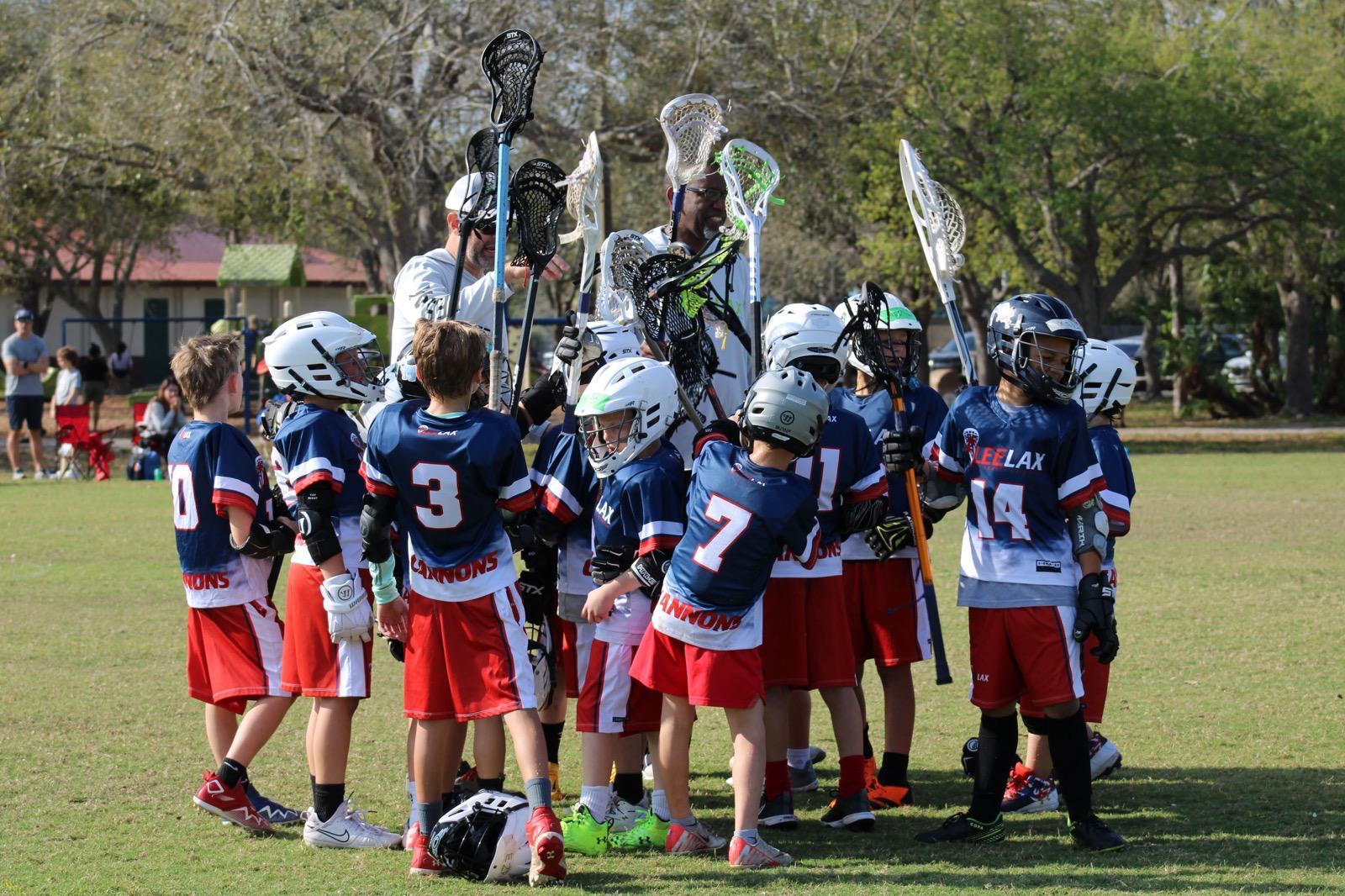 LeeLax youth lacrosse team celebrating on the field